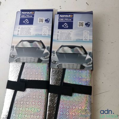 packaging of two silver luggage bags sitting on top of a white table