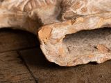 a piece of bread that is sitting on a wooden table