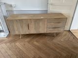 a wooden cabinet in the corner of a room