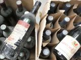 many bottles of wine sitting in a cardboard box