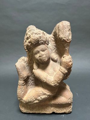 an ancient statue of a woman holding a child