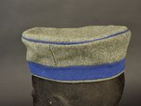 a hat with a blue band on it on a mannequin head