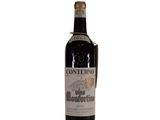 the bottle of wine is sitting on a white surface