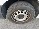 a tire with holes on the rim of a car