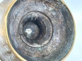 a close up of a metal object on a white surface
