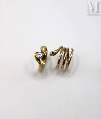 an image of a pair of gold rings with a diamond in the middle