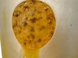a close up view of a yellow object in a glass