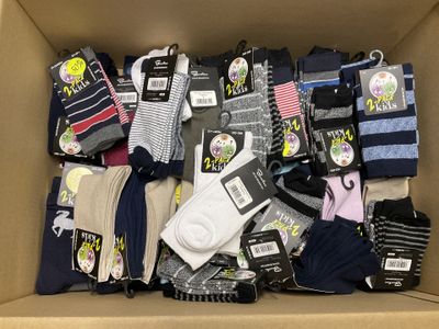 many pairs of socks in a box with tags on them