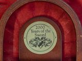a plaque on the wall that says 2000 years of the sword