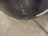 a close up of a car ' s bumper with a denting on it