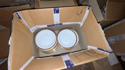 two empty bowls in a cardboard box on the floor