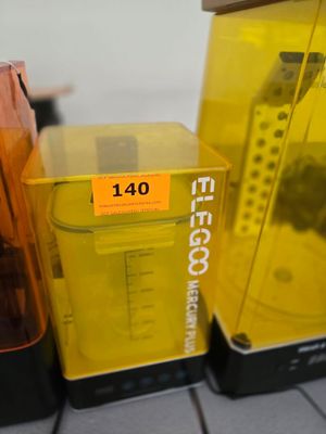 a yellow blender sitting on a counter next to other items