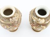 two vases that are sitting on a white surface