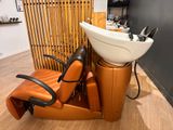 a chair with a sink and a hair dryer on it