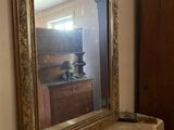 a mirror that is on a mantle in a room