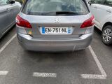 a silver car parked in a parking lot next to other cars