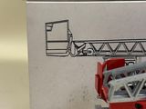 a red fire truck that is sitting in front of a box