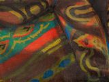 a painting of a woman laying on a colorful blanket