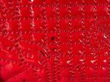 a close up view of water droplets on a red surface