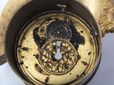 a close up of a gold clock with a clock face