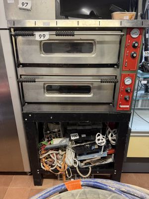 three ovens stacked on top of each other in a kitchen