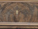 a close up of a wooden dresser with a key on it
