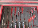 many different tools in a red box on the floor