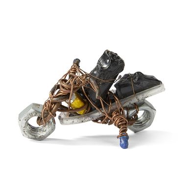 a sculpture of a motorcycle with a bunch of shoes on it