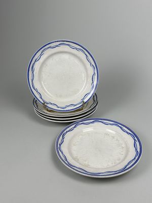 two plates with blue rims on them sitting on top of each other