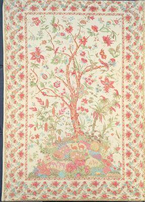 a tapestry with a tree and flowers on it