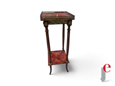 a small table that has a red and gold design on it