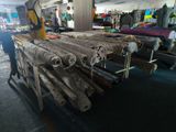 many rolls of fabric on a table in a store