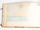 an open book with a drawing of a beach scene on it