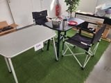 a table and chairs in a room with a green carpet