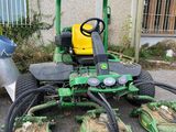 a picture of a lawn mower parked in front of a building