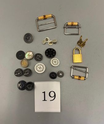 many different types of buttons and clasps on a table