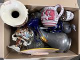 a cardboard box filled with assorted vases and other items
