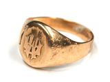 an image of a gold signet ring with a dollar symbol on it