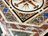 a marble table with a clock on it in a room
