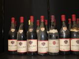 several bottles of wine are lined up on a shelf
