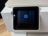 a white printer sitting on top of a wooden table