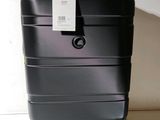 a black suitcase with a tag on it sitting on the floor