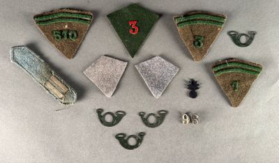 five pieces of green and brown cloth on a white surface