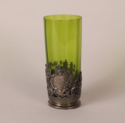 green glass vase with a metal base and a silver decoration
