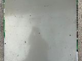 a mirror on the floor with a reflection of a person in it