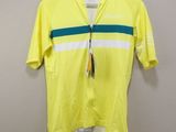 a close up of a yellow shirt hanging on a hanger