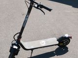 a scooter that is sitting in the parking lot