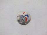 an image of a coin with a rooster on it on a white surface