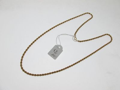 a close up of a necklace with a tag attached to it