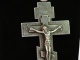 silver cross with jesus on the cross on a black necklace